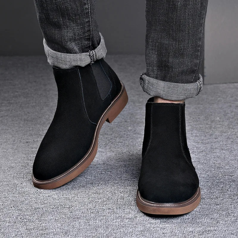 Modelo usando botas Chelsea masculinas pretas com calça jeans